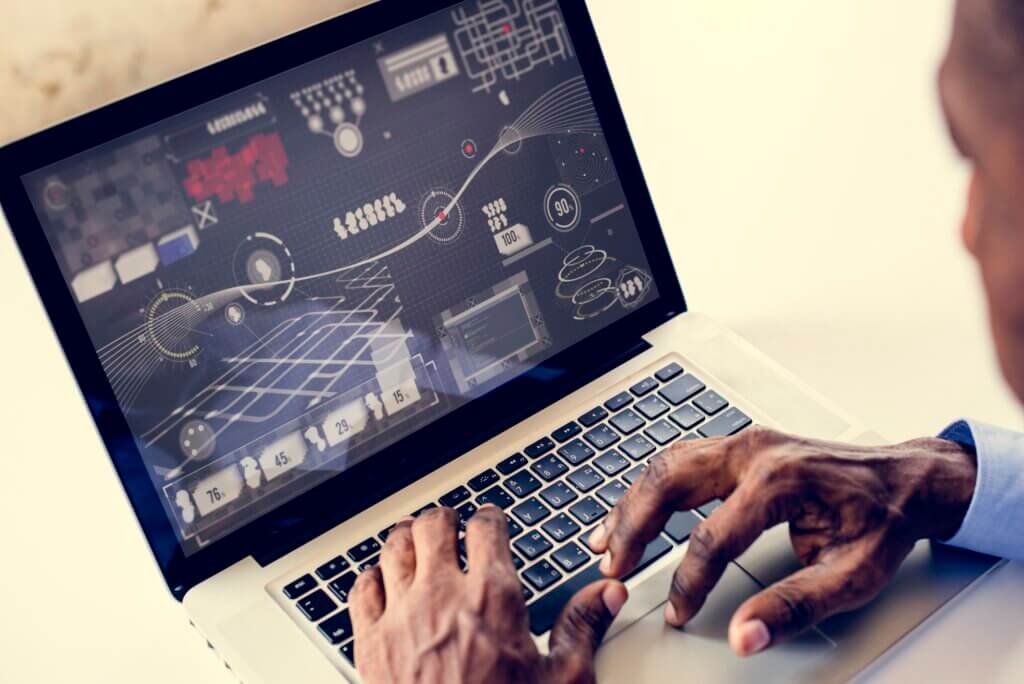 African ethnicity man working with infographic on laptop